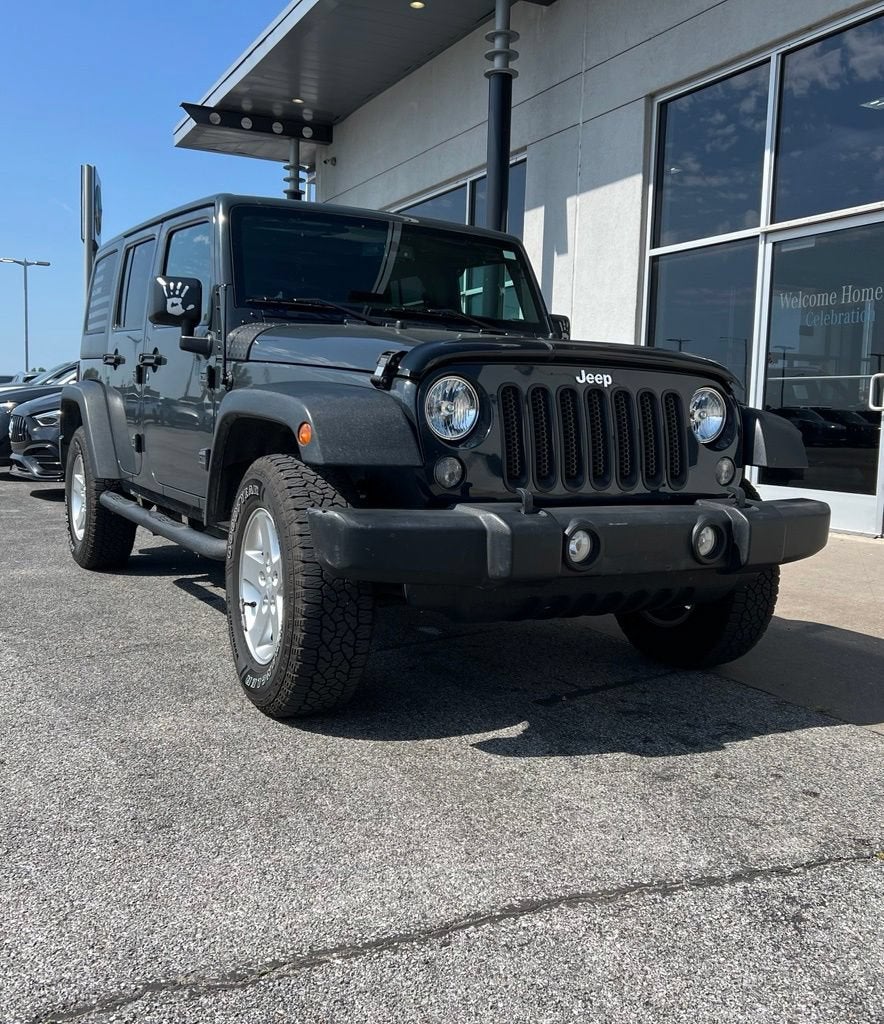 2016 Jeep Wrangler Unlimited Sport in Black — front three-quarter view